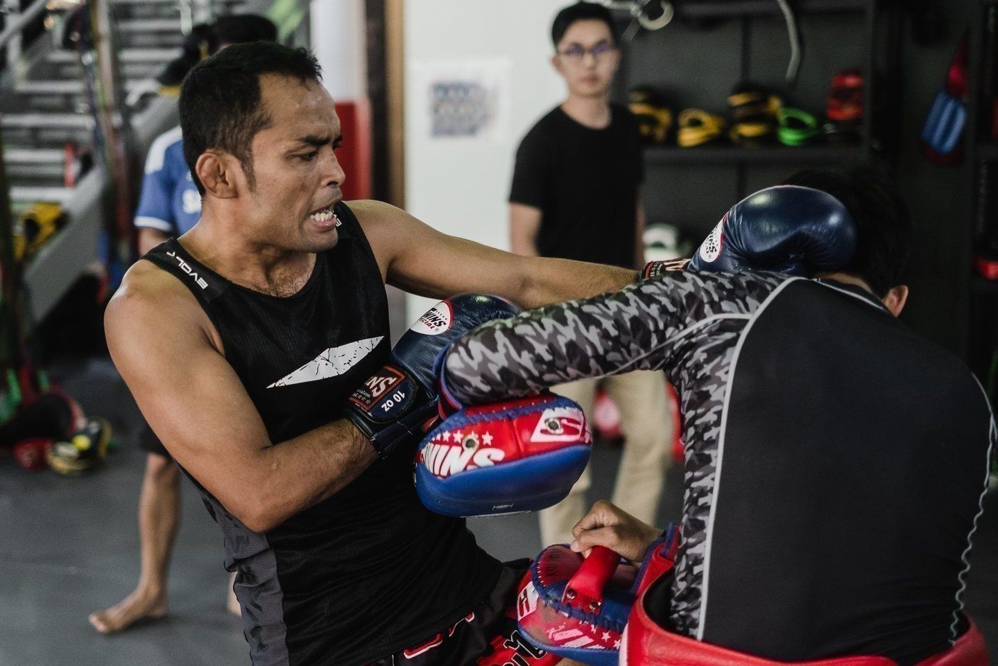 Dejdamrong throws a knee during a Muay Thai class at Evolve MMA in Singapore.