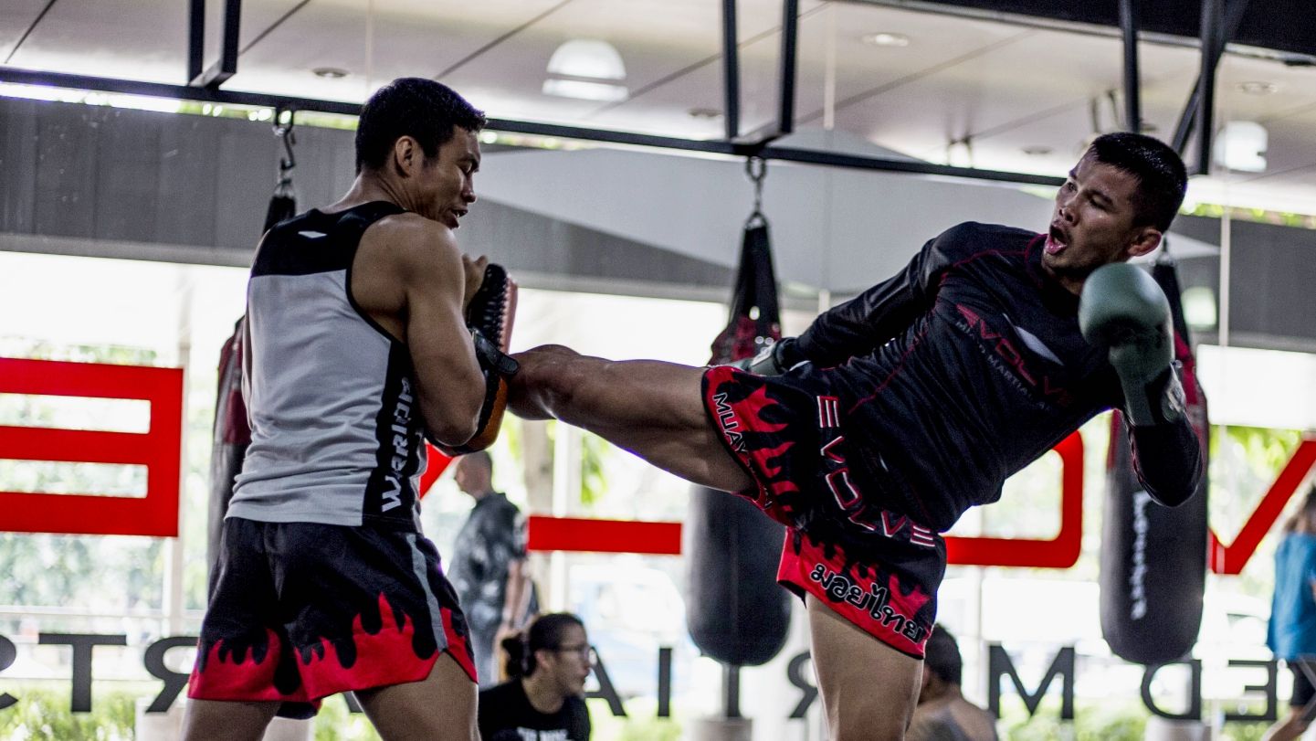 Nong-O kicking the pads during a Muay Thai class